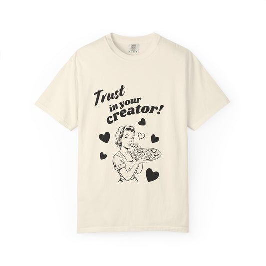 Beige t-shirt with graphic design and text 'Trust in your creator!' on a white background