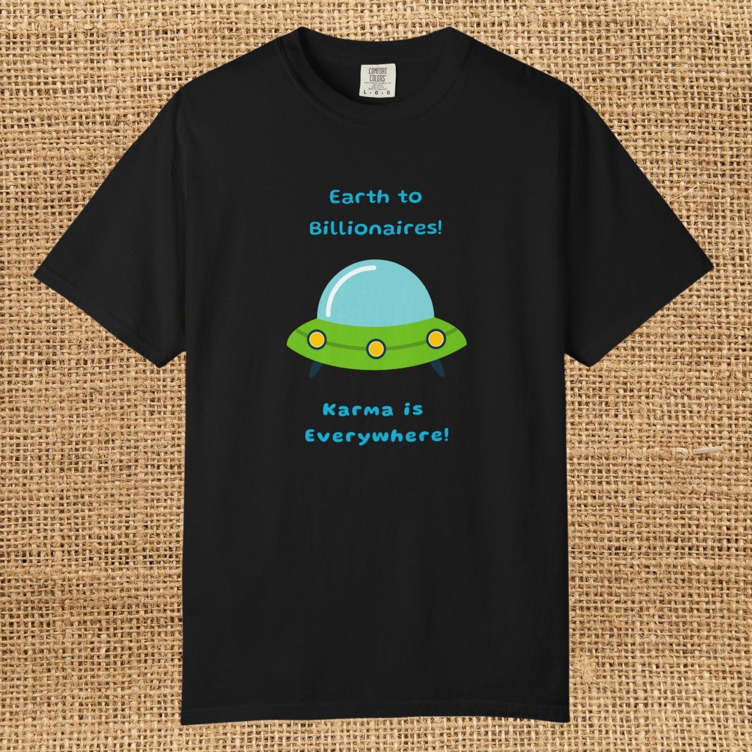 Image of a green & blue cartoon style space ship. Text says "Earth to billionaires, karma is everywhere."