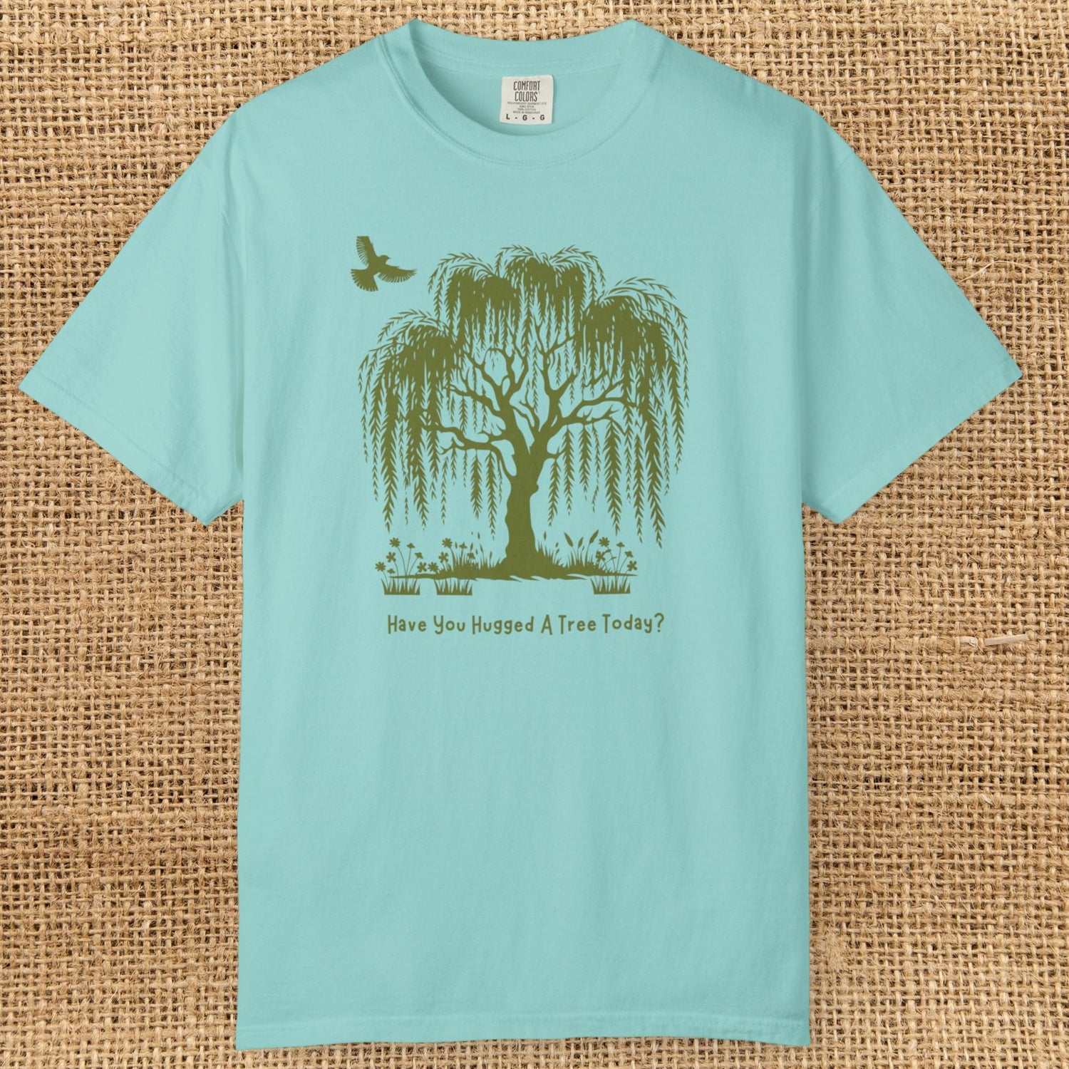 Weeping Willow Tree with bird soaring above. Text says "Have you hugged a tree today."