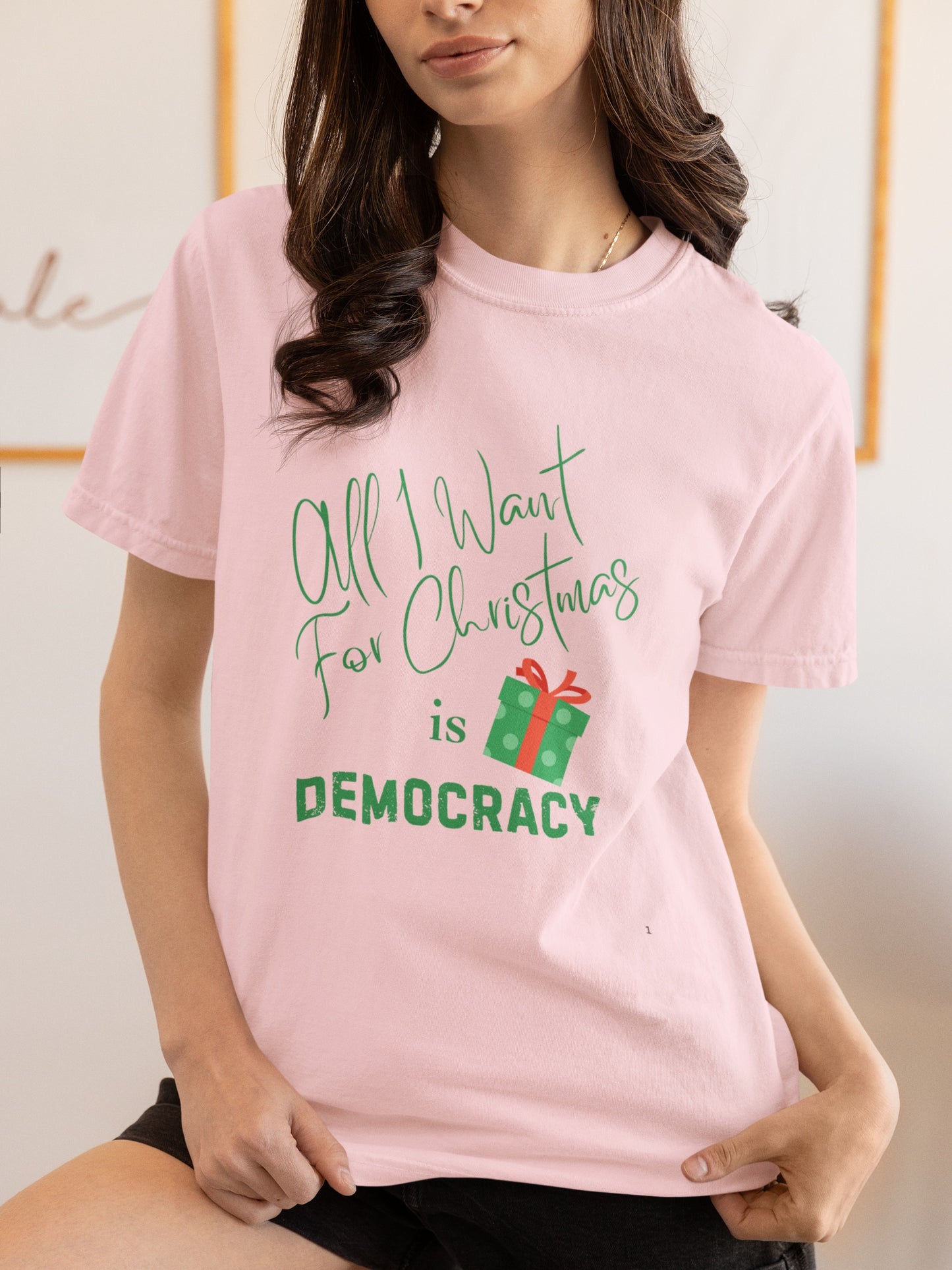 Person wearing a pink t-shirt with a Christmas-themed message.