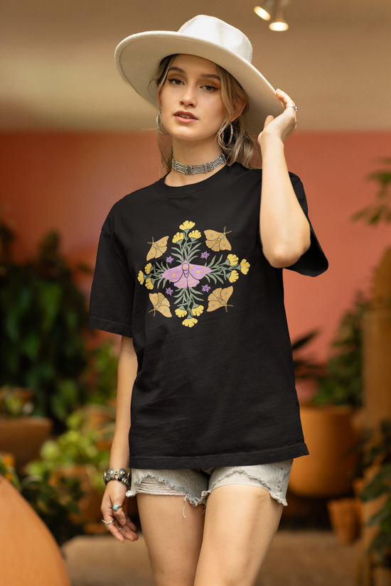 black organic cotton t-shirt with graphic of butterflies and flowers in shape of a mandala.