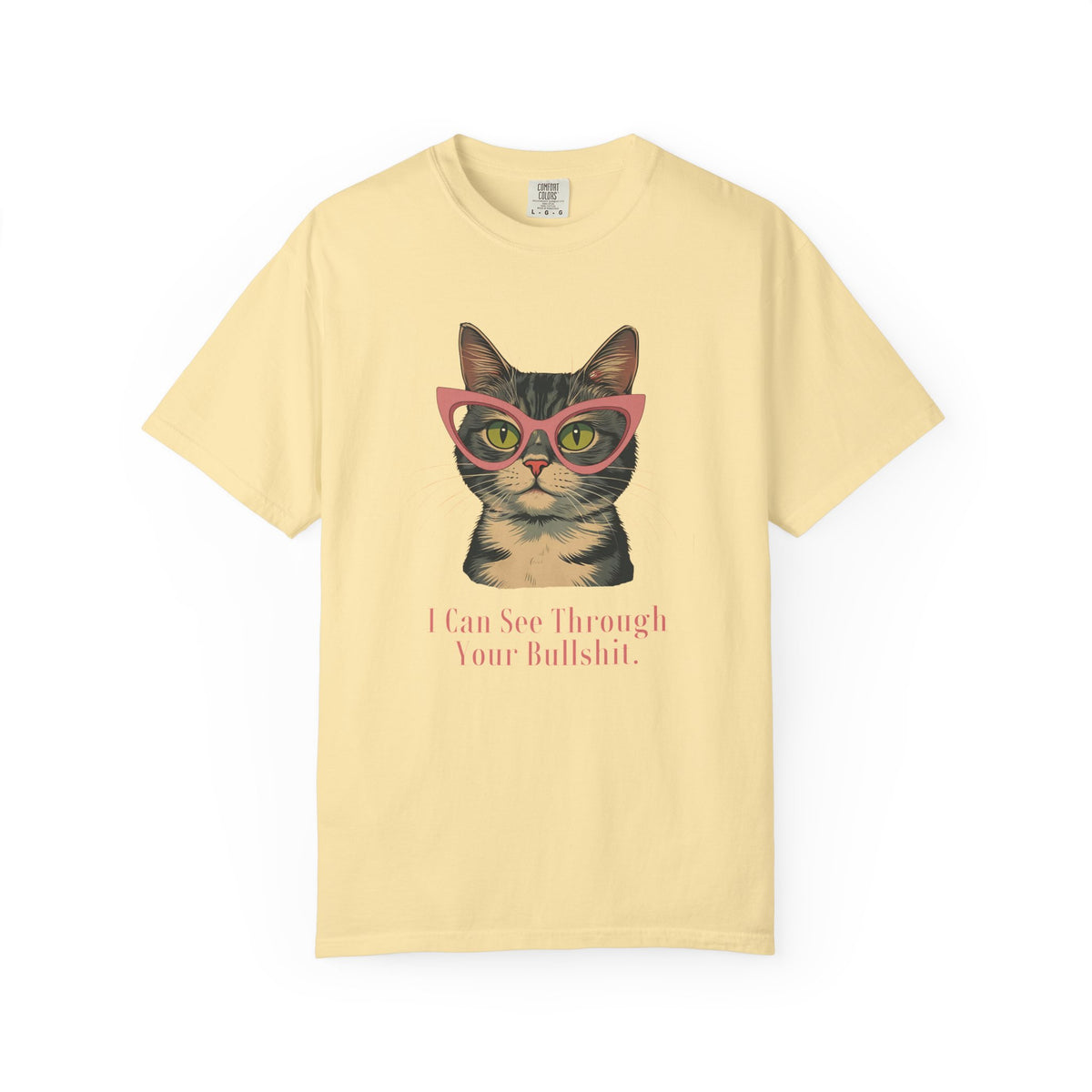 A pale yellow short-sleeve t-shirt with a graphic of a tabby cat wearing pink glasses and the text 'I Can See Through Your Bullshit.' printed below, displayed on a clean white background.