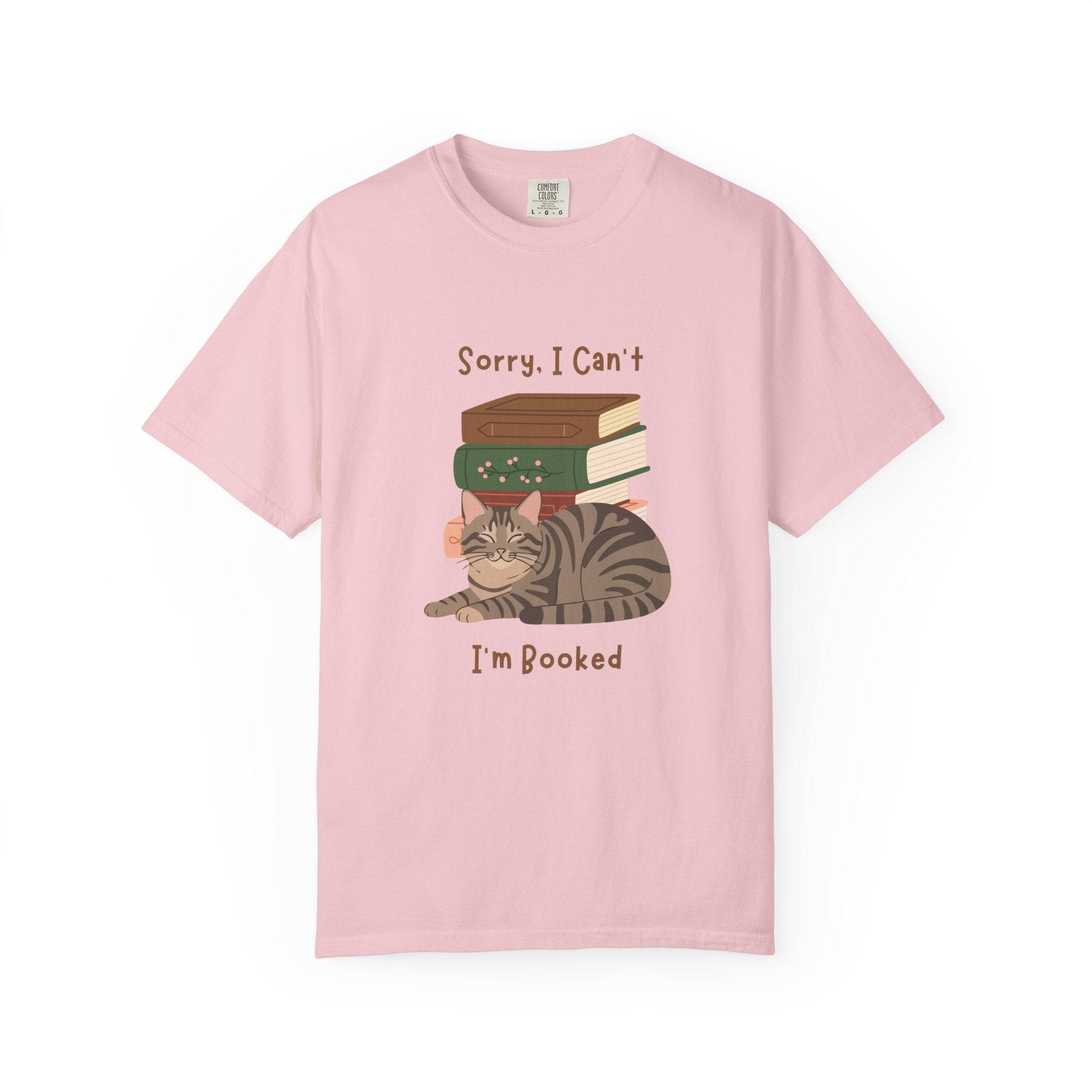 Pink cotton tshirt with graphic of a cat laying in front of stack of books.  Text says, Sorry, I can't.  I'm booked.