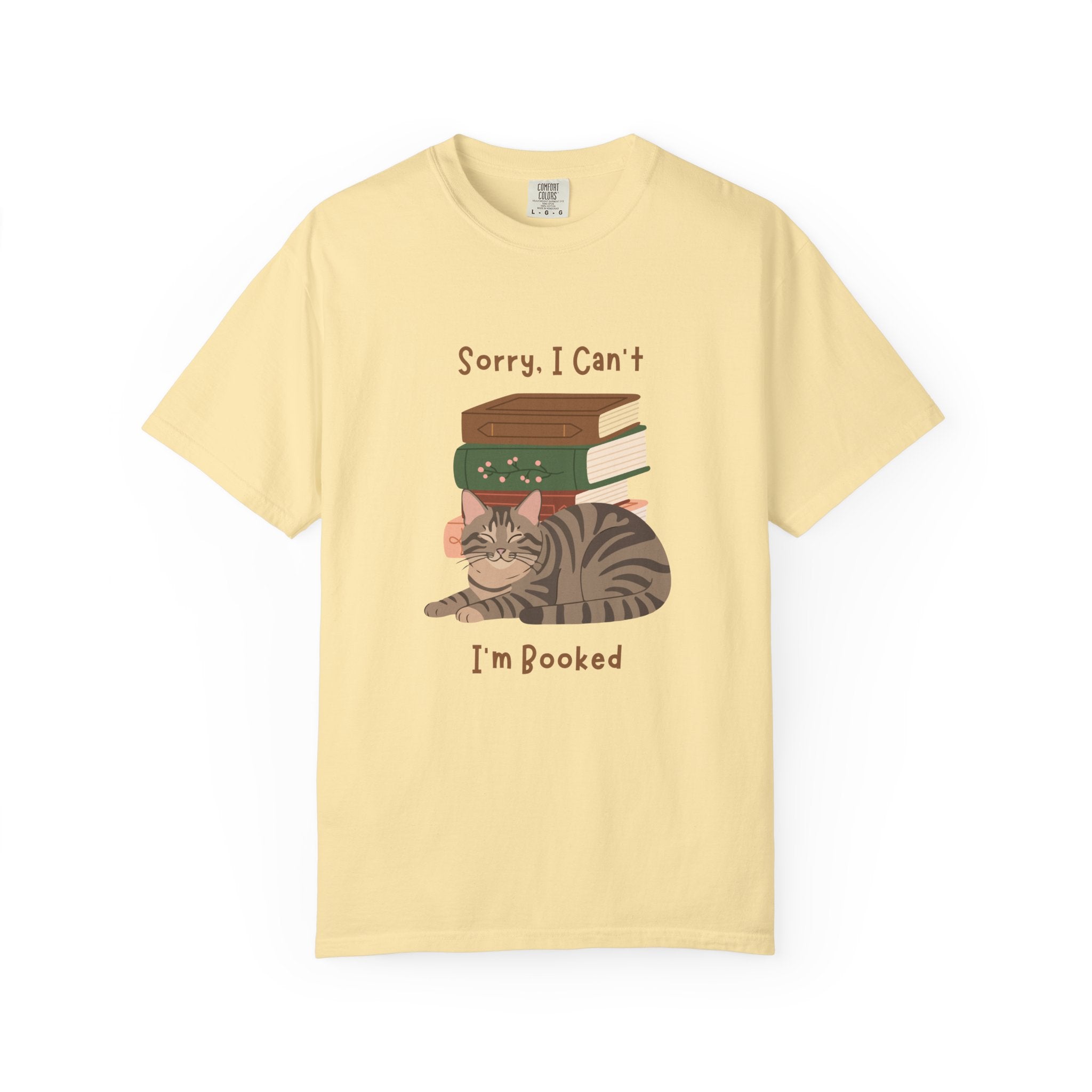 Yellow cotton tshirt with graphic of a cat laying in front of stack of books.  Text says, Sorry, I can't.  I'm booked.