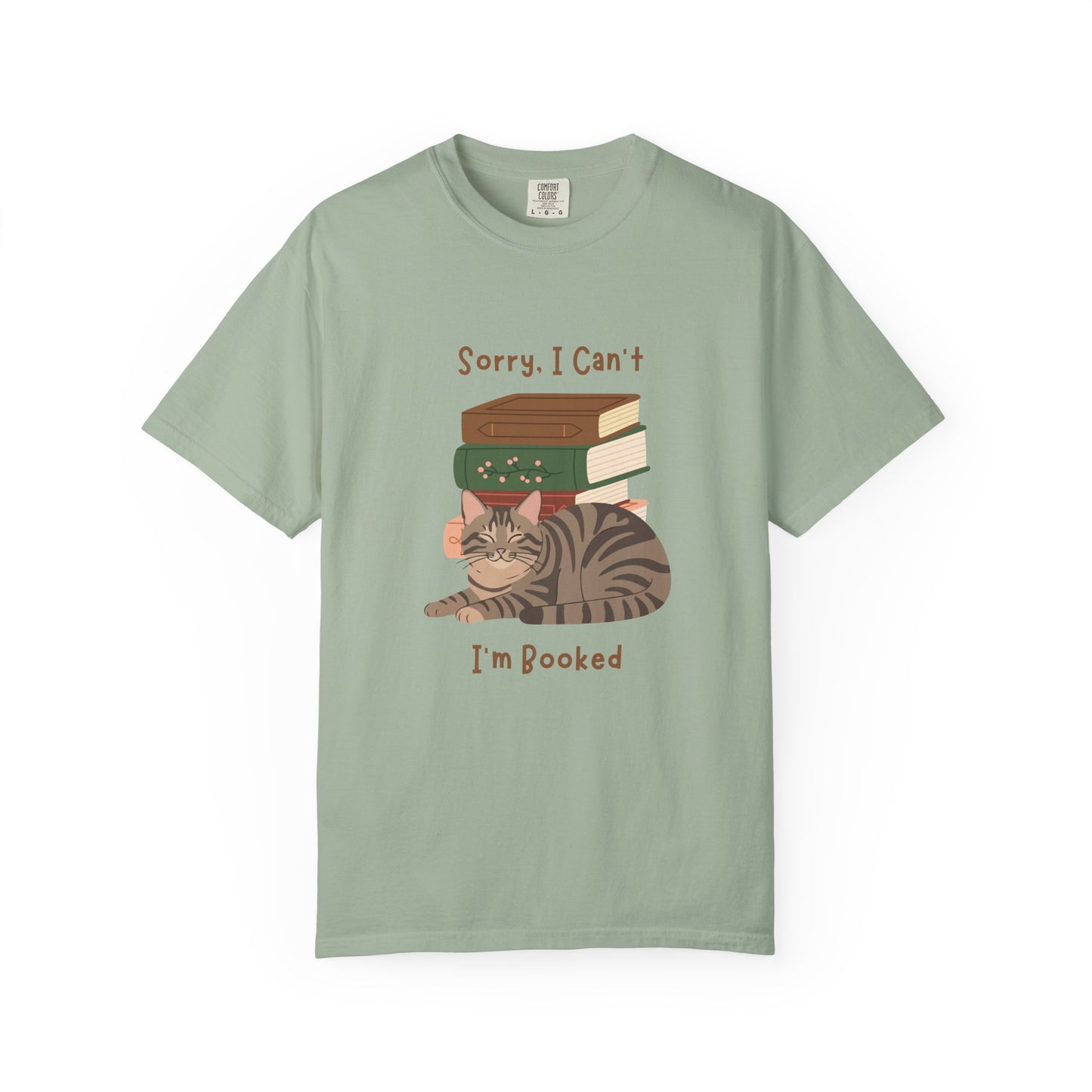 Green cotton tshirt with graphic of a cat laying in front of stack of books.  Text says, Sorry, I can't.  I'm booked.