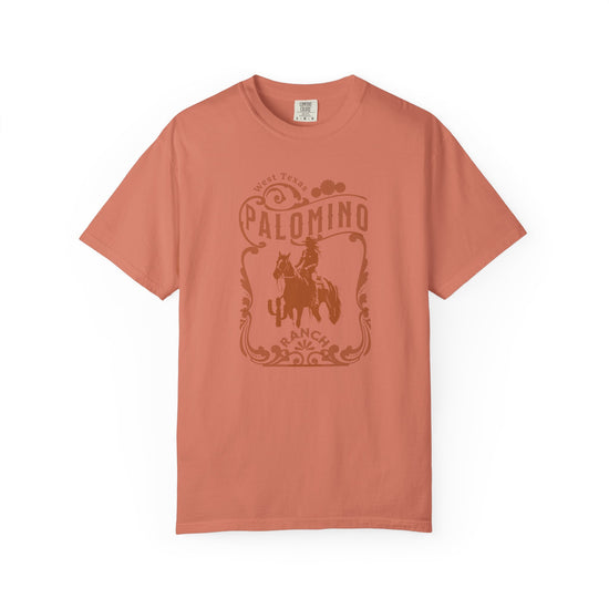 Orange  t-shirt with a graphic design of a horse and rider, and 'Palomino Ranch' text 