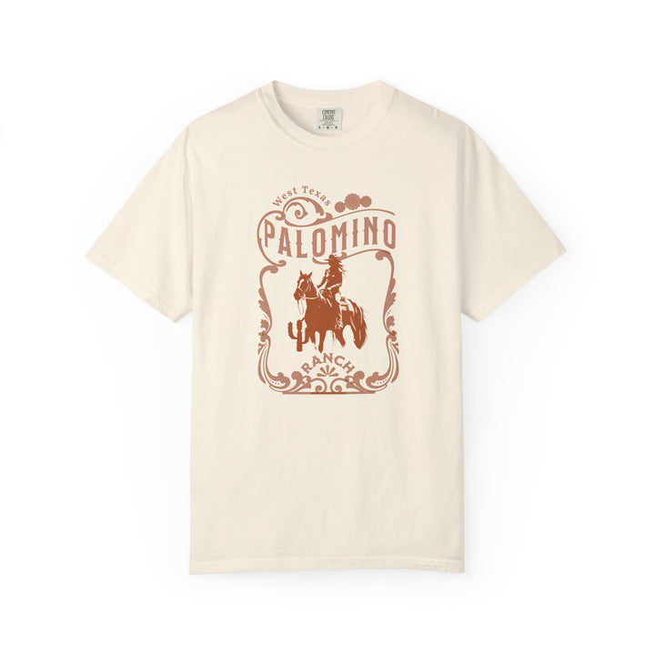 Ivory t-shirt with a graphic design of a horse and rider, and 'Palomino Ranch' text 