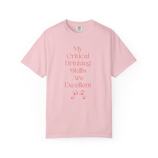 Pink short sleeve, crew neck t-shirt has text that says "My critical drinking skills are excellent" and  a graphic of two martini glasses.