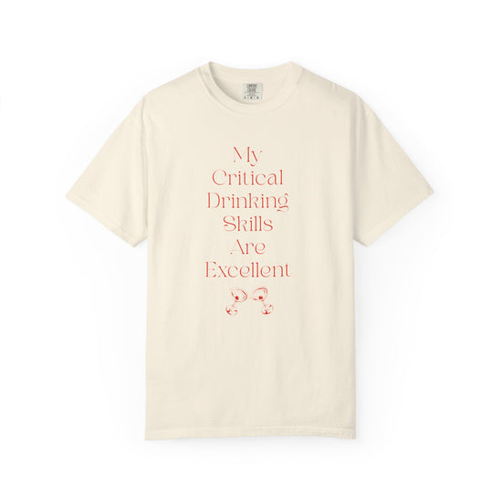 Ivory short sleeve, crew neck t-shirt has text that says "My critical drinking skills are excellent" and  a graphic of two martini glasses.