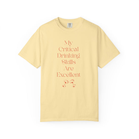 Yellow short sleeve, crew neck t-shirt has text that says "My critical drinking skills are excellent" and  a graphic of two martini glasses.