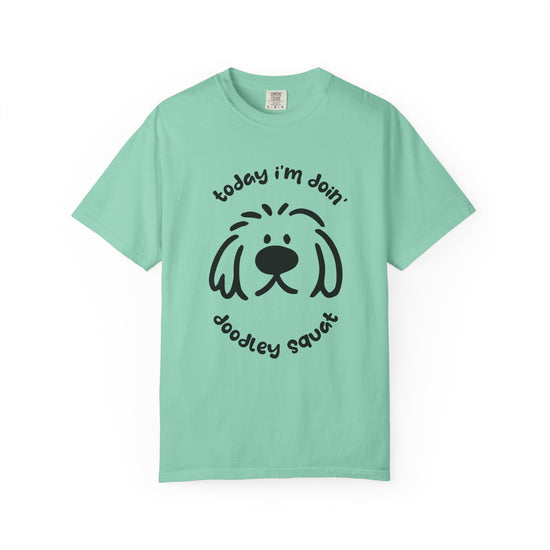 Teal short-sleeve crewneck t-shirt featuring a black graphic of a dog's face with the text 'Today i'm Doin' Doodley Squat" displayed on a clean white background.