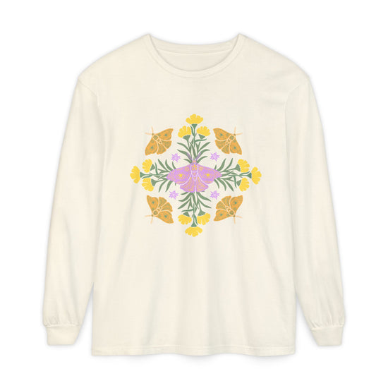 An off-white long-sleeve crewneck t-shirt featuring a colorful central graphic of a purple butterfly surrounded by yellow flowers and green leaves, with orange butterflies on either side. A mandala.