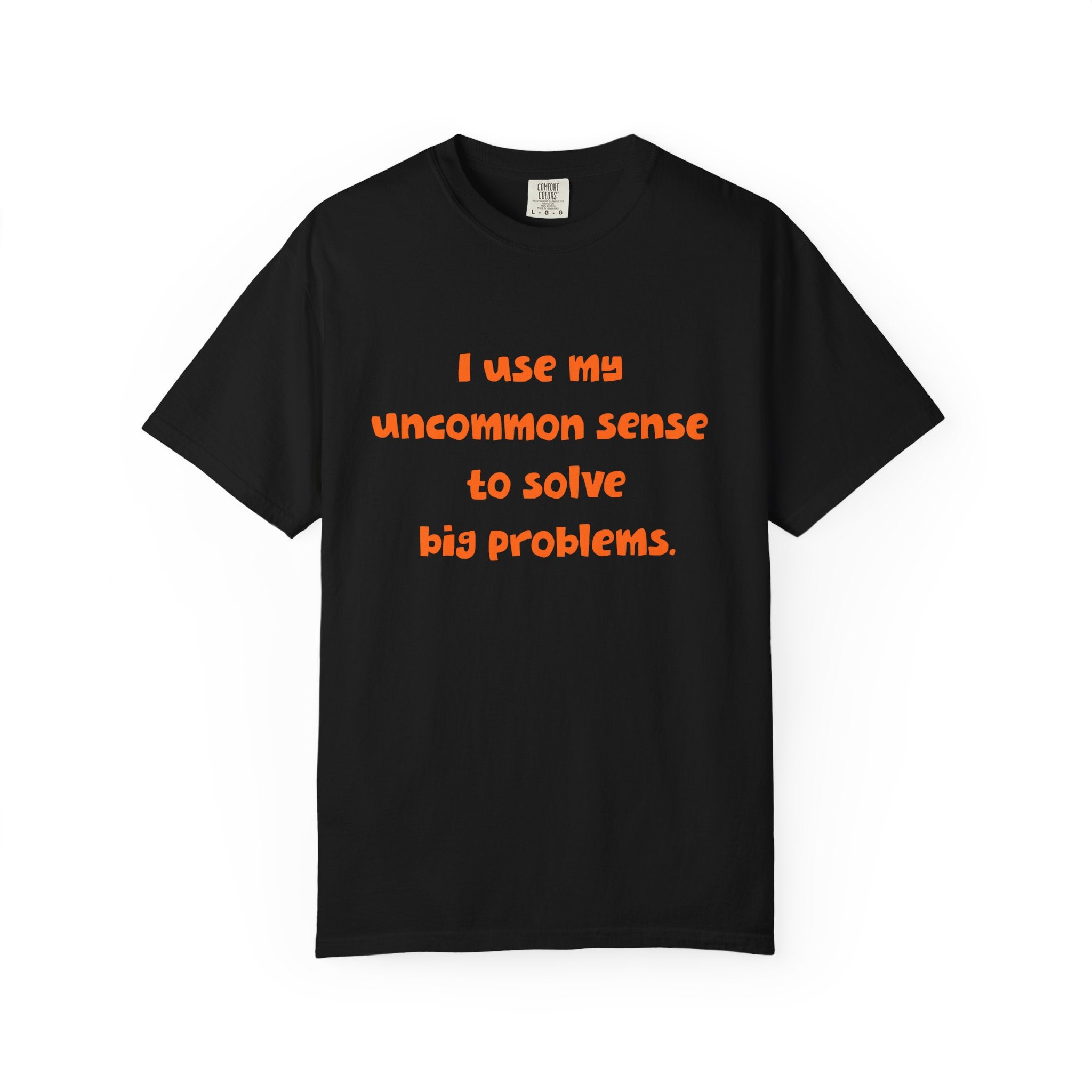 Black short sleeve, crew neck t-shirt has orange type that says "I use my uncommon sense to solve big problems."