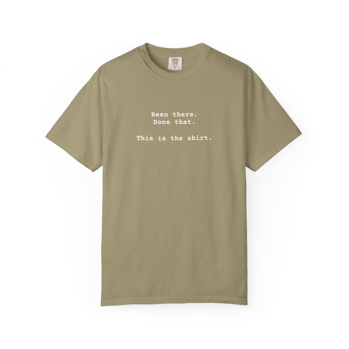 Khaki -shirt with text on a white background says "Been There.  Done That.  Here's The T-shirt" in a simple typewriter font.