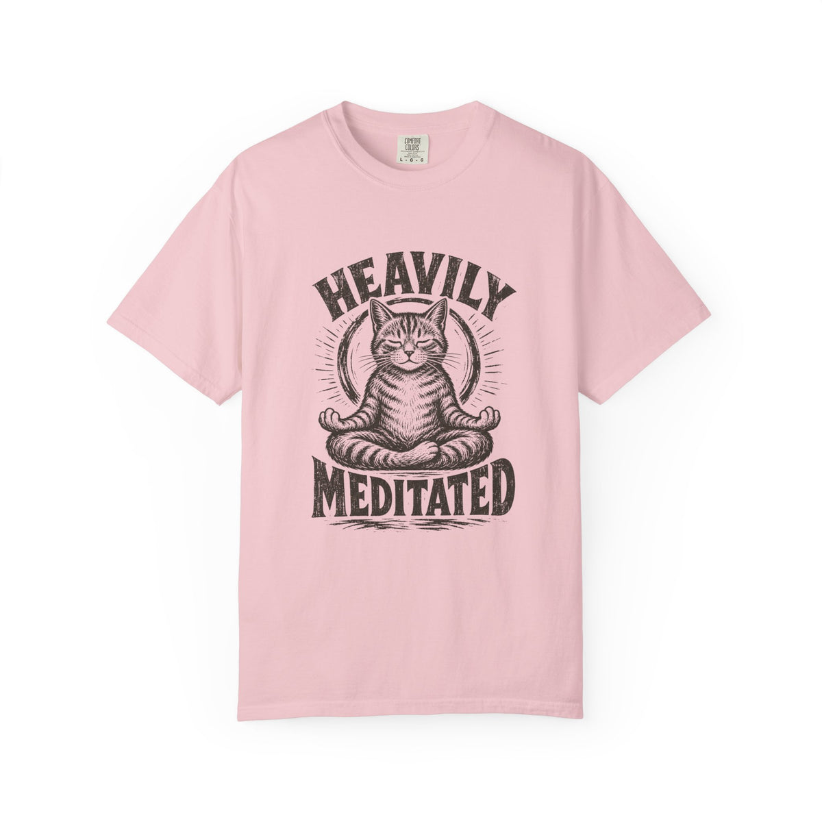 Pink  short-sleeve, crew-neck t-shirt with a black graphic print of a cat meditating, with the text 'HEAVILY MEDITATED' arched above and below the cat.