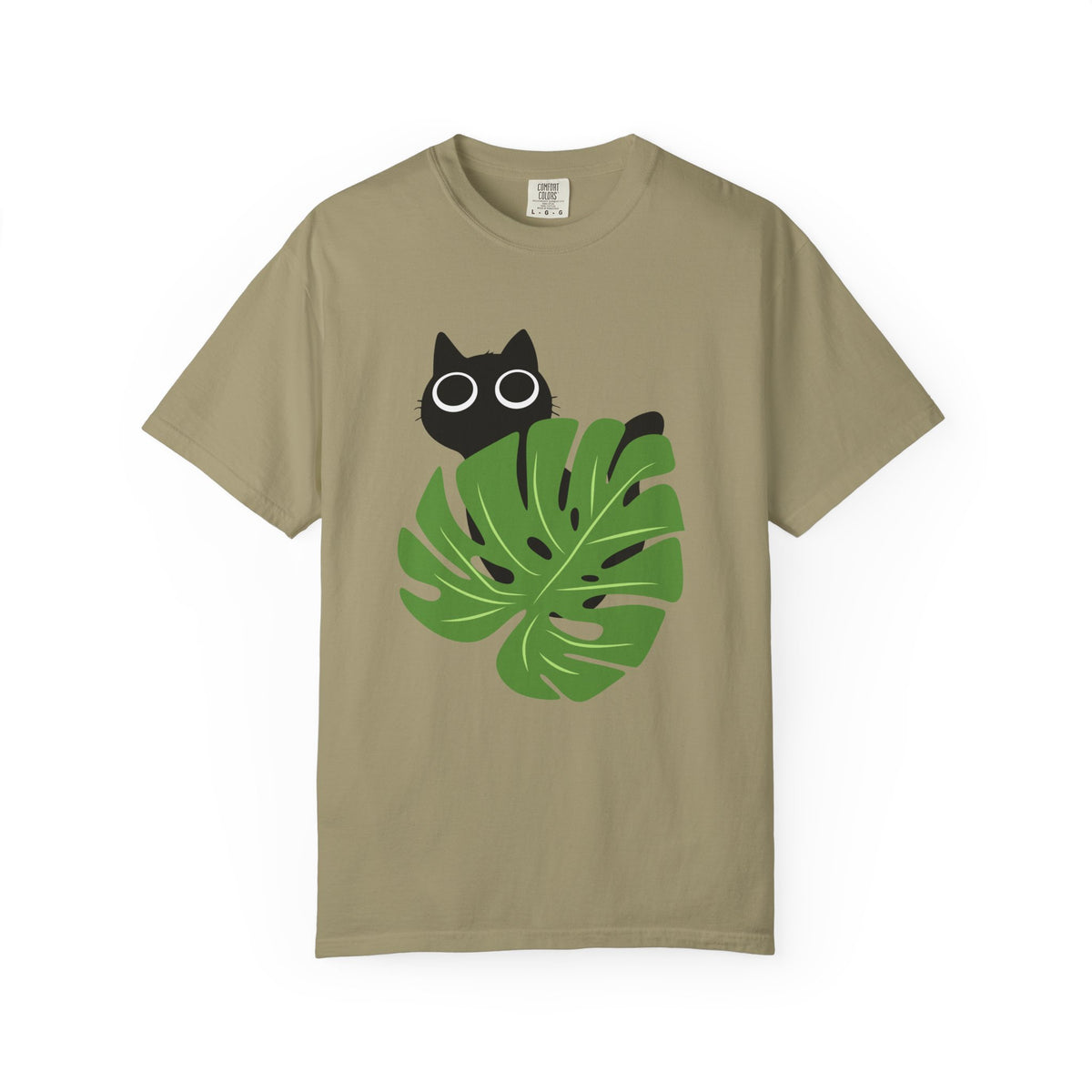 A khaki short-sleeve crewneck t-shirt featuring a graphic of a black cat peeking over a green monstera leaf with white-rimmed glasses, displayed on a clean white background.