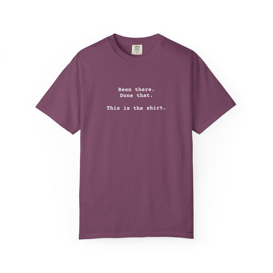Purple t-shirt with text on a white background says "Been There.  Done That.  Here's The T-shirt" in a simple typewriter font.