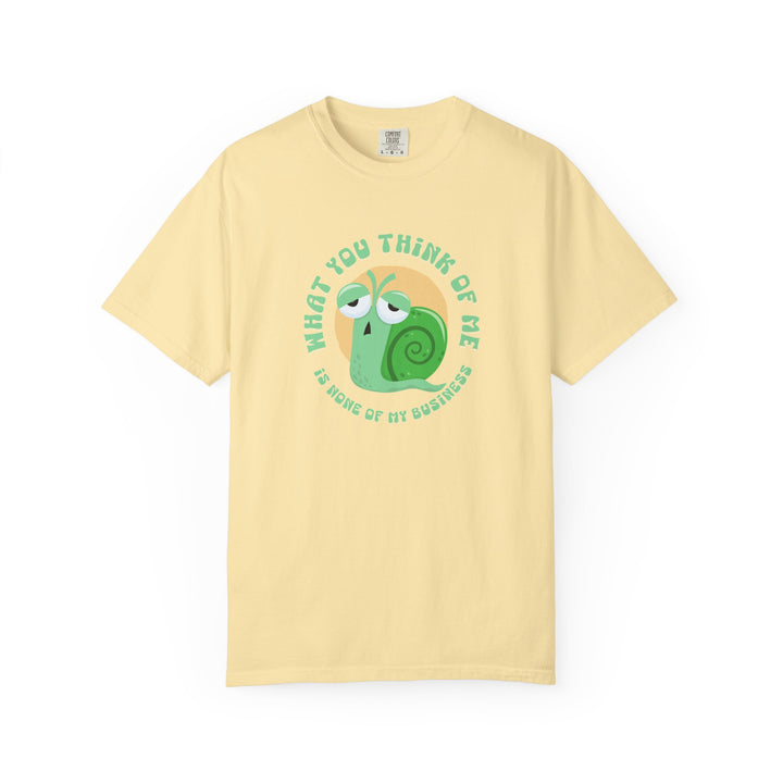 A yellow short-sleeve crewneck t-shirt featuring a cartoon graphic of a green snail inside a yellow circle, with the text 'WHAT YOU THINK OF ME IS SOME OF MY BUSINESS' printed around it.