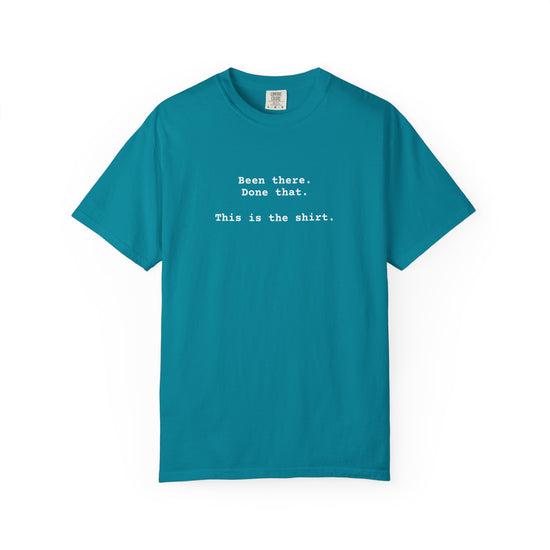 Blue t-shirt with text on a white background says "Been There.  Done That.  Here's The T-shirt" in a simple typewriter font.