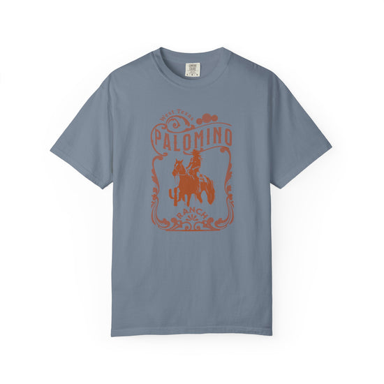 blue t-shirt with a graphic design of a horse and rider, and 'Palomino Ranch' text 