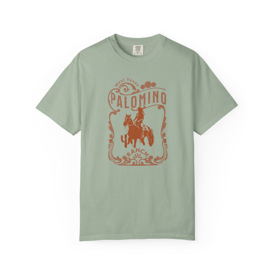 Green t-shirt with a graphic design of a horse and rider, and 'Palomino Ranch' text 
