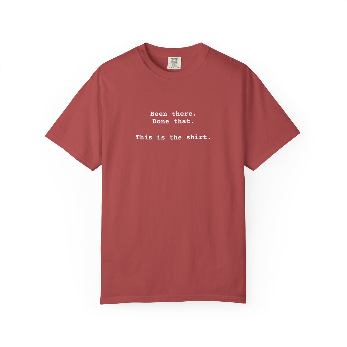 red t-shirt with text on a white background says "Been There.  Done That.  Here's The T-shirt" in a simple typewriter font.